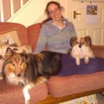 The author, Caroline Ward pictured with one dog on her lap and one sitting next to her on the couch