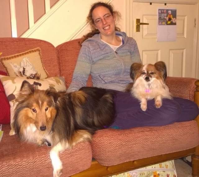 The author, Caroline Ward pictured with one dog on her lap and one sitting next to her on the couch