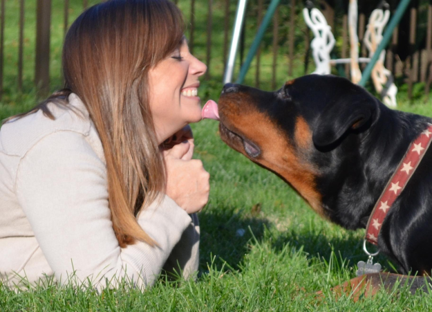 Kym Iffert gives her Rottweiler Chopper a kiss