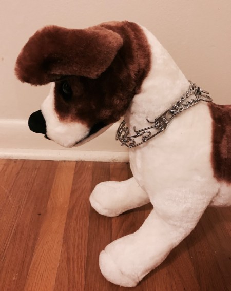 stuffed dog modeling a loosely fitted prong collar