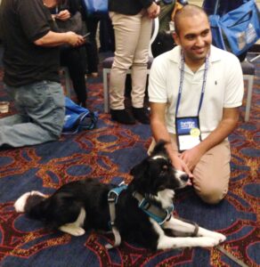 Panelist and presenter, Chirag Patel, meets Zoey, owned by summit attendee,  Alyssa Buller (not pictured)