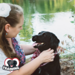 Author Kate LaSala sharing a moment with a black dog. 