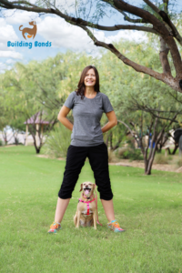The article's author, Kim Silver, with dog, Marly and the building bonds logo.