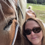 The author of this article, Mary Richards, standing next to a horse