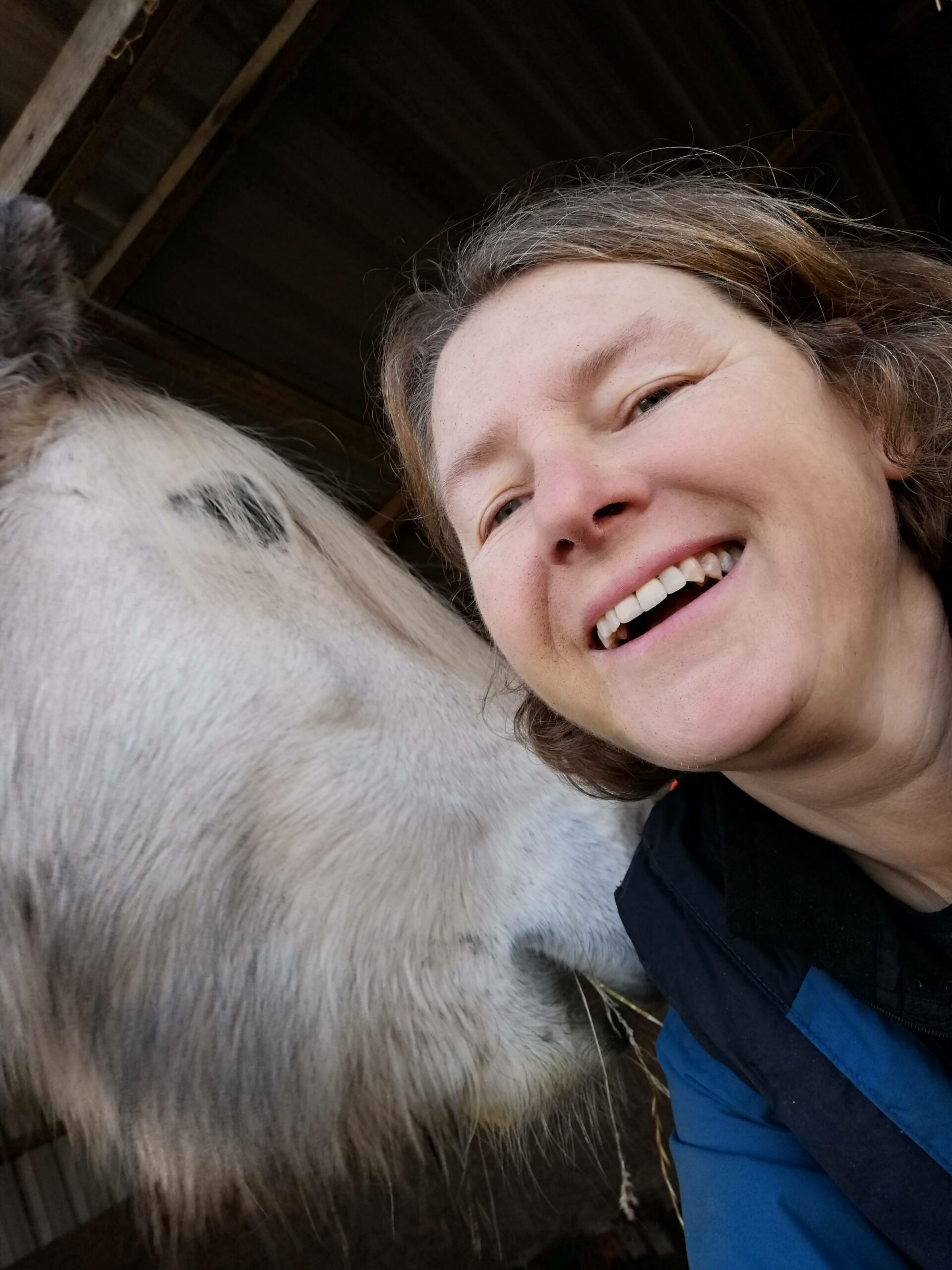 Photo of author, Dorothy Heffernan, smiling with an equid