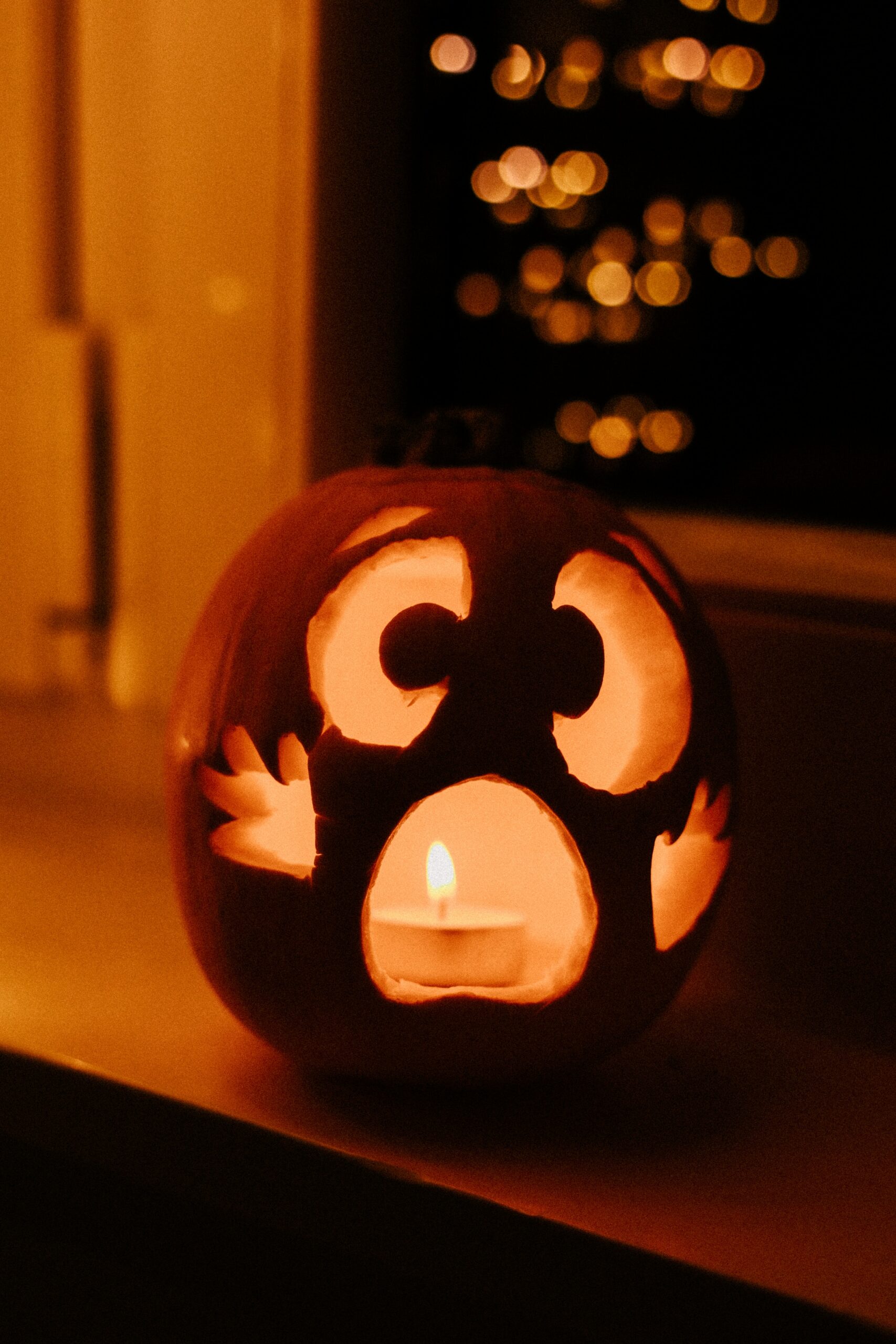 A candlelit jack-o'-lantern with a surprised face