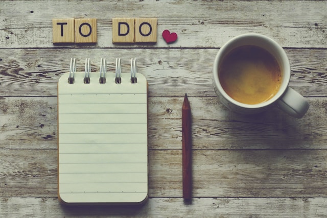 note pad, pen, cup of coffee